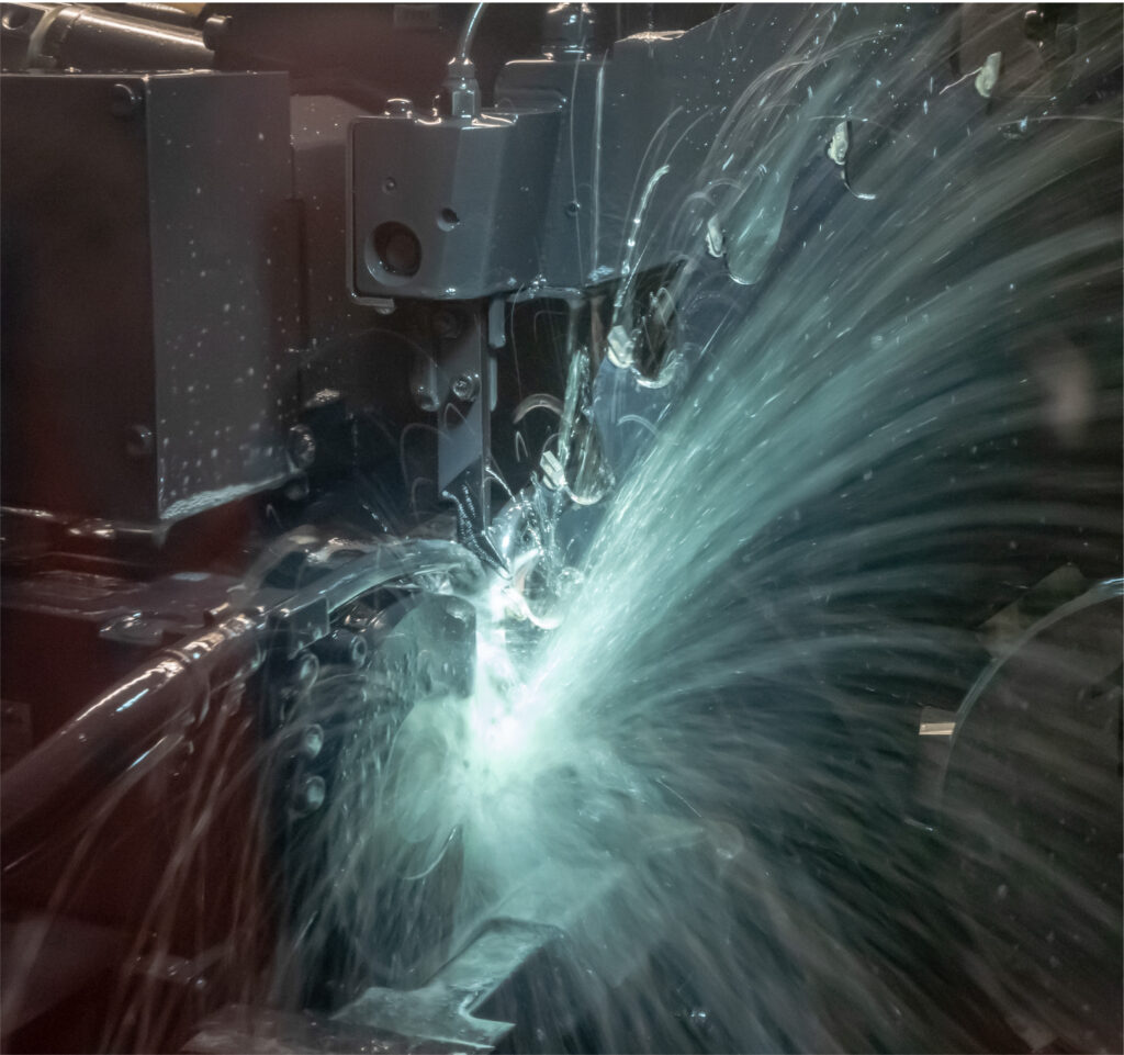 Industrial machine performing machining with coolant spraying