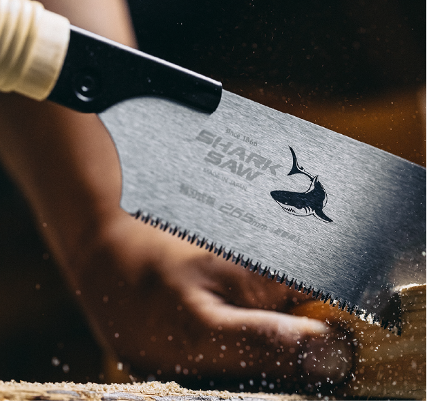 Close-up of a Japanese Shark Saw 265 mm cutting wood with precision.