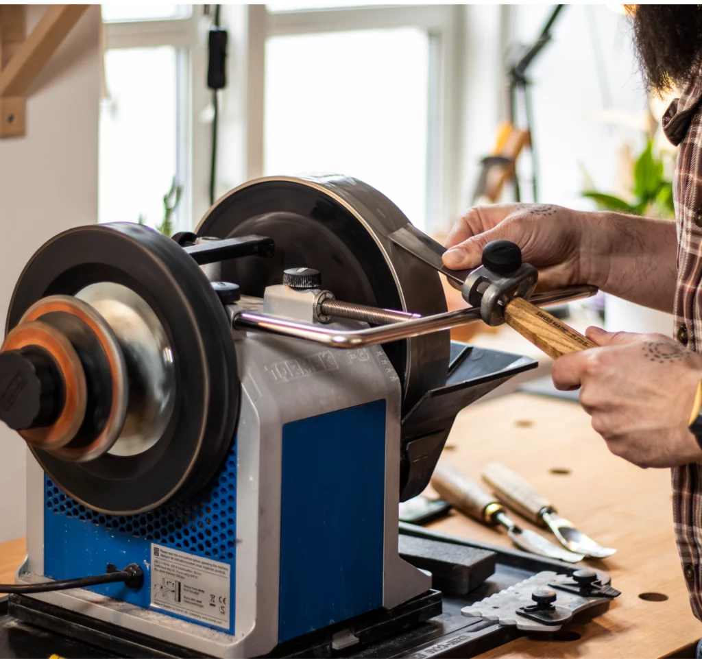 Precise sharpening of chisels with a Tormek T-8 sharpener on a carpenter's bench.
