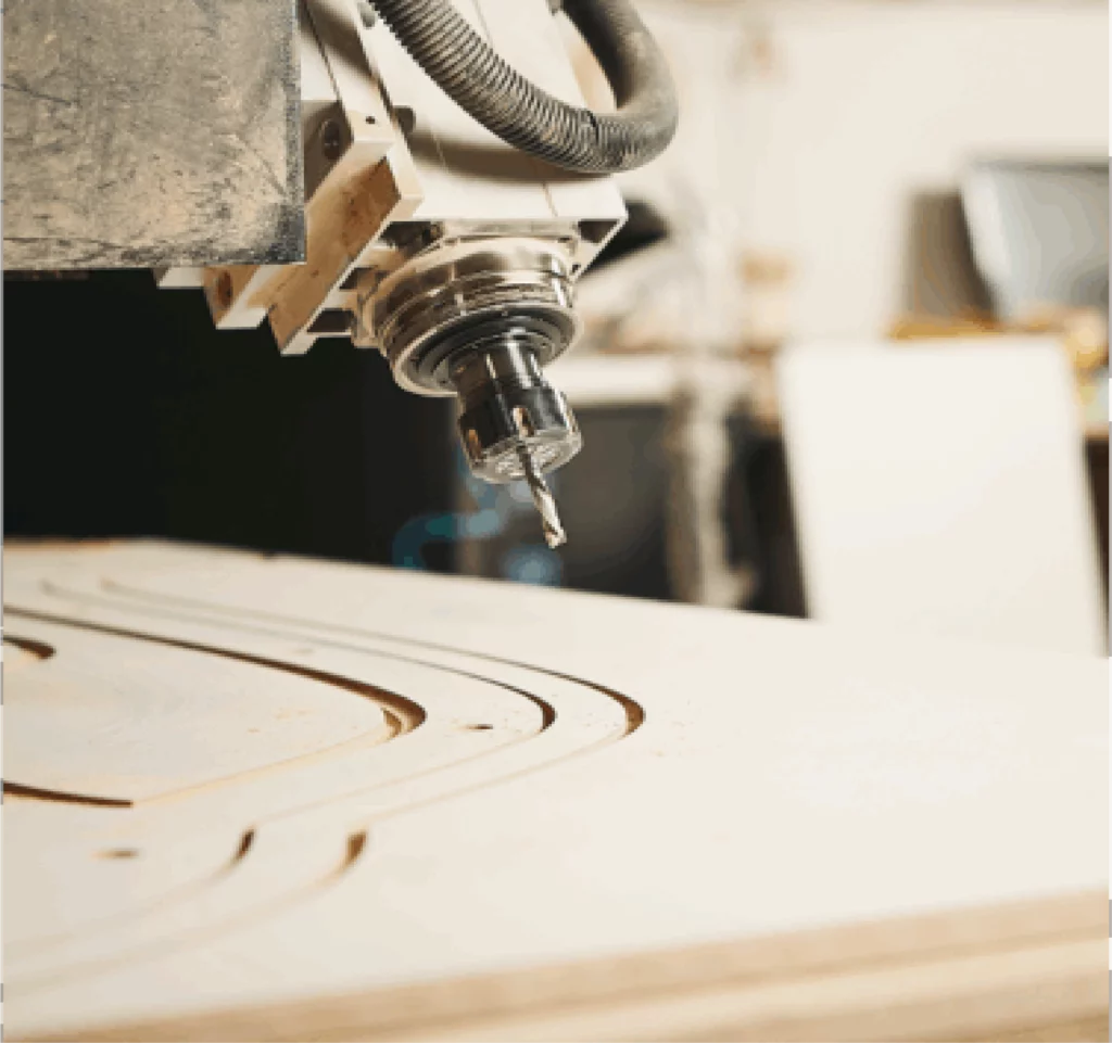 CNC milling head for precision cutting on a wooden panel.